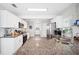 Spacious kitchen featuring granite countertops, stainless steel appliances, and wood-look flooring at 705 Lake Ada Blvd, Dundee, FL 33838