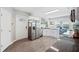 Modern kitchen featuring stainless steel appliances, white cabinetry, and granite countertops at 705 Lake Ada Blvd, Dundee, FL 33838