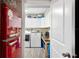 Laundry room with a retro-style refrigerator, washer and dryer, and storage cabinets at 705 Lake Ada Blvd, Dundee, FL 33838
