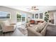 Cozy living room with hardwood floors, a ceiling fan, and sliding glass doors to the outdoor deck at 705 Lake Ada Blvd, Dundee, FL 33838