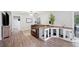 Open-concept living area featuring wood floors, a large dog kennel, and comfortable furnishings at 705 Lake Ada Blvd, Dundee, FL 33838