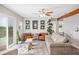 Cozy living room with comfortable seating, ceiling fan, and access to the outdoor deck at 705 Lake Ada Blvd, Dundee, FL 33838