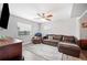 Comfortable living room with a large sectional and wood flooring, complemented by natural light at 705 Lake Ada Blvd, Dundee, FL 33838