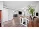 Spacious open-concept living area featuring pet kennel furniture and wood-look floors at 705 Lake Ada Blvd, Dundee, FL 33838