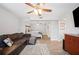 Relaxing living room seamlessly connected to the bedroom with stylish flooring and neutral tones at 705 Lake Ada Blvd, Dundee, FL 33838