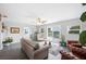 Inviting living room with stylish decor, hardwood floors, and views of the peaceful outdoors at 705 Lake Ada Blvd, Dundee, FL 33838