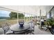 Enclosed patio with outdoor seating and scenic views of the surrounding landscape at 705 Lake Ada Blvd, Dundee, FL 33838