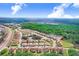 An aerial view of a neighborhood with townhomes near a pond and a wooded area at 116 Ocean Bluff Dr # 116, Kissimmee, FL 34759