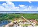 Beautiful aerial view of the property near a lake, trees, and other residences at 116 Ocean Bluff Dr # 116, Kissimmee, FL 34759