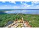 Great aerial view of the property near the lake, trees, and other residences at 116 Ocean Bluff Dr # 116, Kissimmee, FL 34759