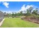 An expansive green lawn borders a tranquil pond with natural vegetation at 116 Ocean Bluff Dr # 116, Kissimmee, FL 34759