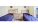 Shot of neutral bedroom with twin beds and shared nightstand at 116 Ocean Bluff Dr # 116, Kissimmee, FL 34759