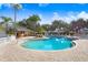 Lovely community pool area featuring palm trees, lounging chairs, and a clubhouse at 116 Ocean Bluff Dr # 116, Kissimmee, FL 34759