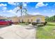 Inviting single-story home featuring a bright yellow exterior, tile roof, well-manicured landscaping, and a spacious driveway at 116 Ocean Bluff Dr # 116, Kissimmee, FL 34759