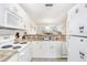 Kitchen area with laminate countertops and white appliances; open to living area at 116 Ocean Bluff Dr # 116, Kissimmee, FL 34759