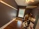 Box filled bedroom with hardwood floors, tree graphic wall, and natural light at 118 S 5Th St, Haines City, FL 33844