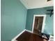 Bright bedroom featuring teal-colored walls and hardwood flooring, showcasing a doorway to another room at 118 S 5Th St, Haines City, FL 33844