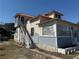 Exterior elevation of home shows the back staircase and entry, siding and foundation at 118 S 5Th St, Haines City, FL 33844