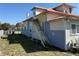 Exterior elevation of home shows staircase and partial yard with metal roof at 118 S 5Th St, Haines City, FL 33844