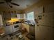 Kitchen with white appliances and cabinets with a stainless steel dishwasher and double sink at 118 S 5Th St, Haines City, FL 33844