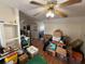 Living room is filled with numerous cardboard boxes and storage containers on hardwood floors at 118 S 5Th St, Haines City, FL 33844