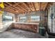 Unfinished basement space featuring exposed beams, concrete walls, and an old workbench at 1290 S Mcadoo Ave, Bartow, FL 33830