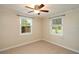 Neutral bedroom with two windows and tile flooring at 1290 S Mcadoo Ave, Bartow, FL 33830