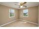 Cozy bedroom featuring tiled floors, a ceiling fan, and natural light from two windows at 1290 S Mcadoo Ave, Bartow, FL 33830