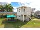 Aerial view of the two-story home showing the balcony, dog kennel, and yard at 1290 S Mcadoo Ave, Bartow, FL 33830