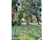 Well-kept front yard with grass and mature trees in the neighborhood at 1290 S Mcadoo Ave, Bartow, FL 33830