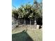 Metal backyard gate with a wire mesh that is partially covered by vines and greenery at 1290 S Mcadoo Ave, Bartow, FL 33830