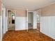 Hallway featuring wood floors, textured walls, white trim, and access to other rooms at 1290 S Mcadoo Ave, Bartow, FL 33830