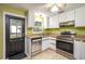 Well-lit kitchen with stainless steel appliances, white cabinets, and a view to the outdoors at 1290 S Mcadoo Ave, Bartow, FL 33830