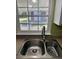 Stainless steel kitchen sink with a view to the backyard at 1290 S Mcadoo Ave, Bartow, FL 33830