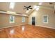 Open living room with high vaulted ceiling, wood floors and natural light from many windows at 1290 S Mcadoo Ave, Bartow, FL 33830