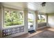 Enclosed front porch with decorative breeze block, front door, and views of the yard at 1290 S Mcadoo Ave, Bartow, FL 33830