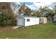 Backyard shed with a roll-up door and a small entry ramp at 1290 S Mcadoo Ave, Bartow, FL 33830