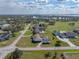 Aerial view of home, garage and pool, situated on a spacious lot near a lake in a rural neighborhood at 1301 Hidden Creek Ct, Winter Haven, FL 33880