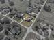 Aerial view of single Gathering house with a brown roof, detached garage and pool with screen enclosure at 1301 Hidden Creek Ct, Winter Haven, FL 33880