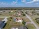 Overhead shot displays neighborhood, mature trees, screened-in lanai, and in-ground pool at 1301 Hidden Creek Ct, Winter Haven, FL 33880