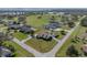 Aerial view of home, garage and pool, situated on a spacious corner lot with mature landscaping at 1301 Hidden Creek Ct, Winter Haven, FL 33880