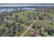 Aerial view of home, garage and pool, situated on a spacious corner lot in a rural neighborhood at 1301 Hidden Creek Ct, Winter Haven, FL 33880