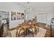 Elegant dining room featuring wood floors, a stylish chandelier, and a view into other living spaces at 1301 Hidden Creek Ct, Winter Haven, FL 33880