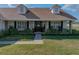 Charming front entrance with brick accents, decorative shutters, and a professionally landscaped yard at 1301 Hidden Creek Ct, Winter Haven, FL 33880