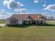 Exterior shot of single-Gathering home boasting a well-manicured lawn and traditional design elements at 1301 Hidden Creek Ct, Winter Haven, FL 33880