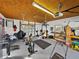 Garage featuring plywood ceiling with a variety of gym equipment and tools at 1301 Hidden Creek Ct, Winter Haven, FL 33880