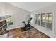 Bright home gym featuring wood floors, white walls, and large windows with plantation shutters at 1301 Hidden Creek Ct, Winter Haven, FL 33880