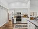 Modern kitchen with stainless steel appliances, white cabinets, and attractive wood-look flooring at 1301 Hidden Creek Ct, Winter Haven, FL 33880