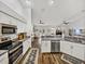 Bright kitchen offering stainless appliances, white cabinetry, and a seamless connection to the living area at 1301 Hidden Creek Ct, Winter Haven, FL 33880