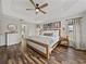 Large main bedroom boasts a tray ceiling, wood floors, and bright windows at 1301 Hidden Creek Ct, Winter Haven, FL 33880